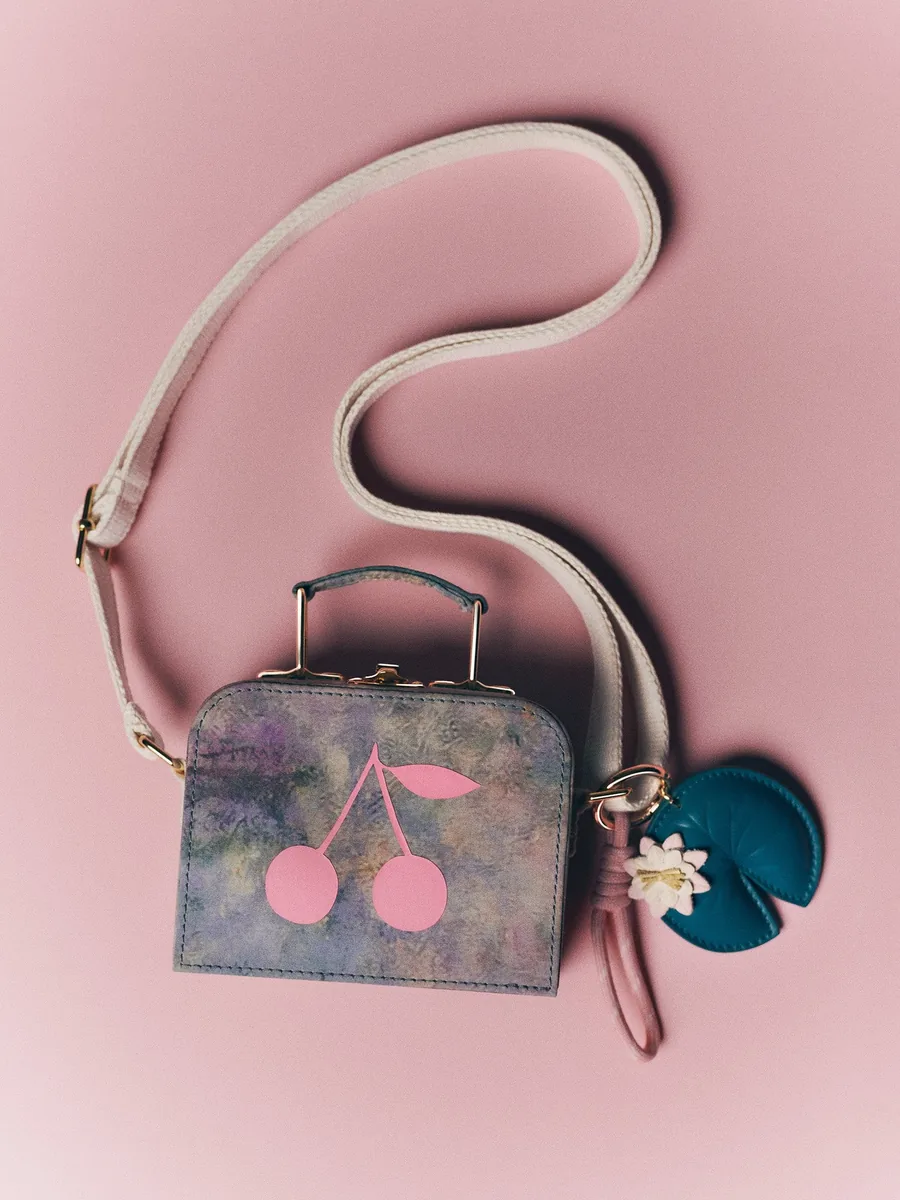 Bonpoint x MoMA small suitcase in the water lily print with a cherry motif and a leather key ring