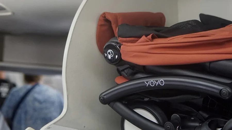 Folded Stokke YOYO⁵ in the overhead locker of an aircraft