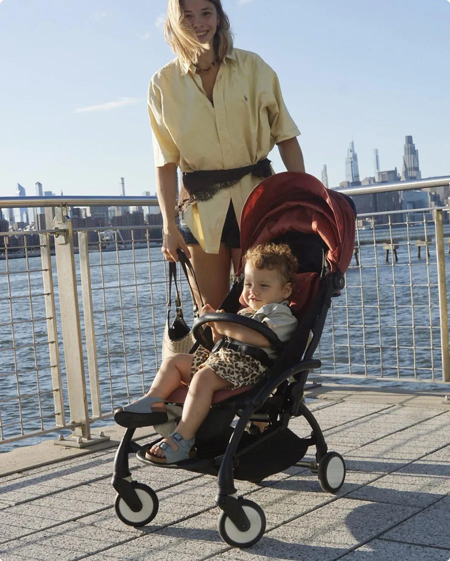 Child in the Stokke YOYO⁵ on a waterfront promenade